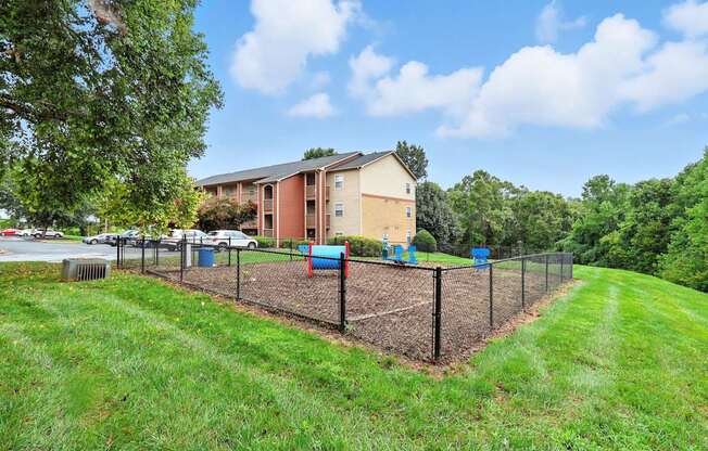 A building with a fenced in yard in front of it.