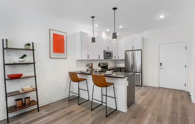 A modern kitchen with a white countertop and a refrigerator.at 829 Garfield, Jersey City, 07305