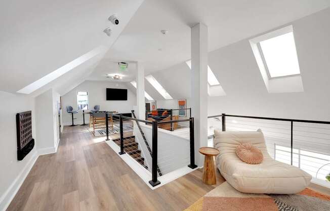 A living room with a white couch and a wooden floor.