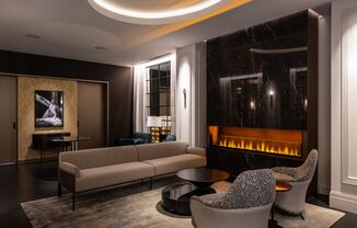 a living room with couches and chairs and a fireplace  at The Belden Stratford, Illinois