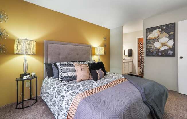 a bedroom with a bed and two lamps