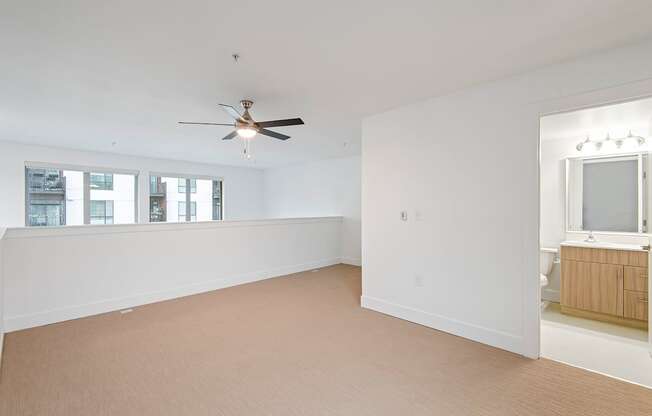 A room with a ceiling fan and a window.