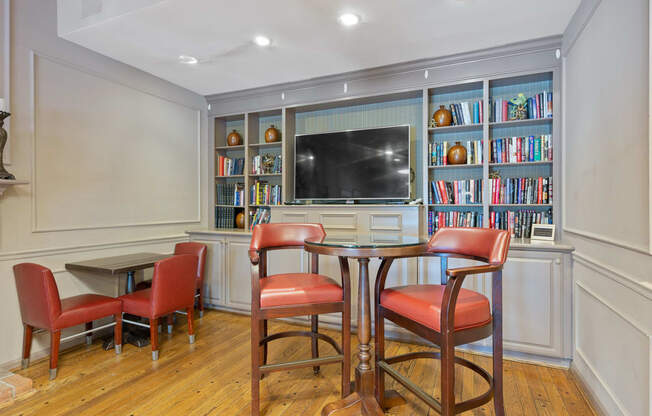 a living room with a table and chairs and a television