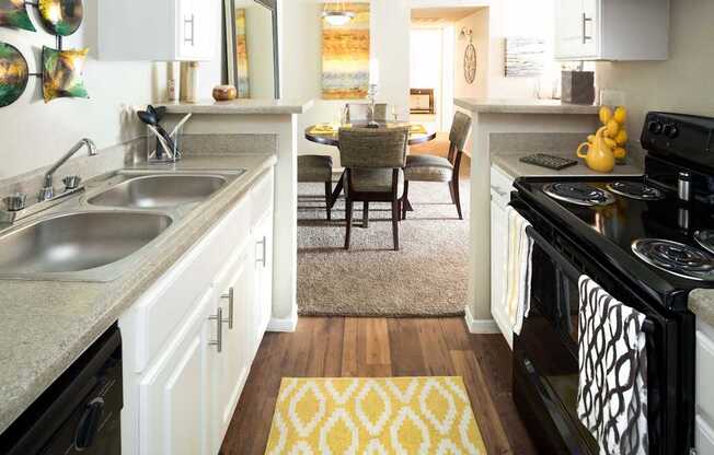 Kitchen with Double Sink, Brushed Nickel Finishes, New Cabinetry, and Black Appliances