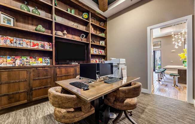 A room with a desk, chairs, and shelves filled with various items.