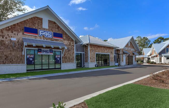 A modern commercial building with wood shingle siding and a metal roof, featuring large glass windows. The F45 fitness studio logo is prominently displayed. The surrounding area includes well-maintained grass and a clear blue sky, creating a welcoming outdoor environment.