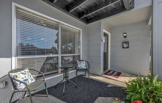 A balcony with a chair and table.