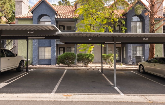 a parking lot with cars parked in front of a building