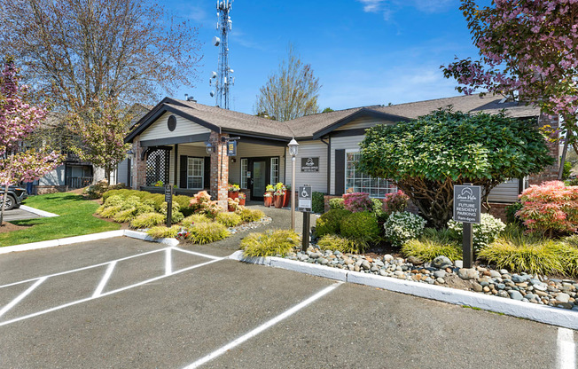 a building with a parking lot and a sign in front of it