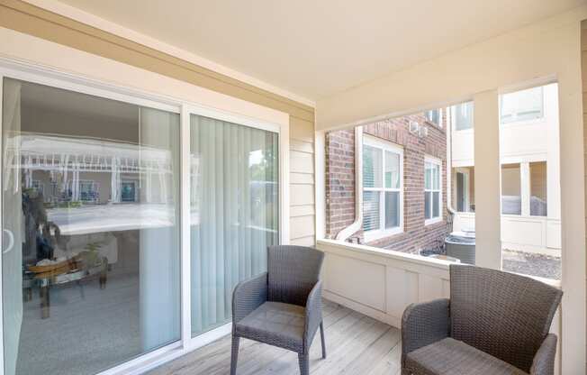 a living room with two chairs and a large window at Butternut Ridge, North Olmsted, 44070