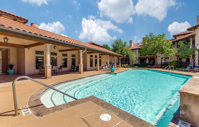 a swimming pool with a house in the background