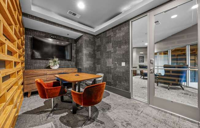 A conference room with a wooden table and chairs.