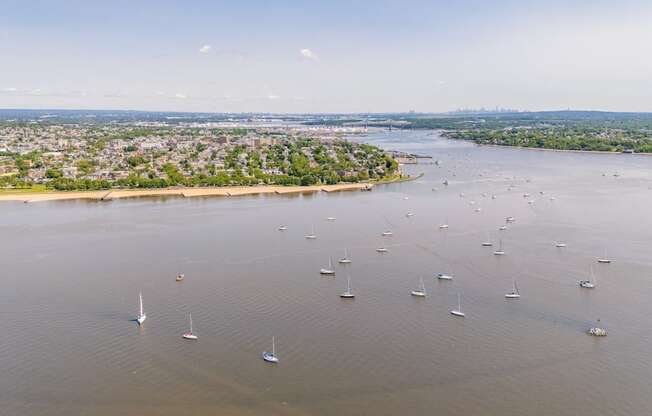 A large body of water with many sailboats floating on it.