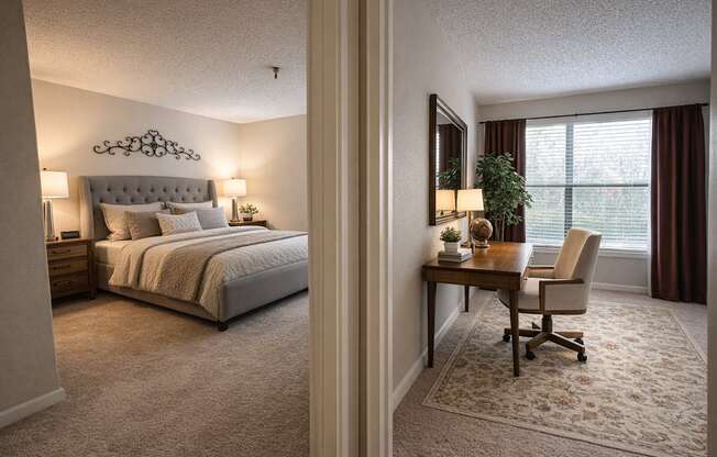 A bedroom with a bed, desk, and chair.