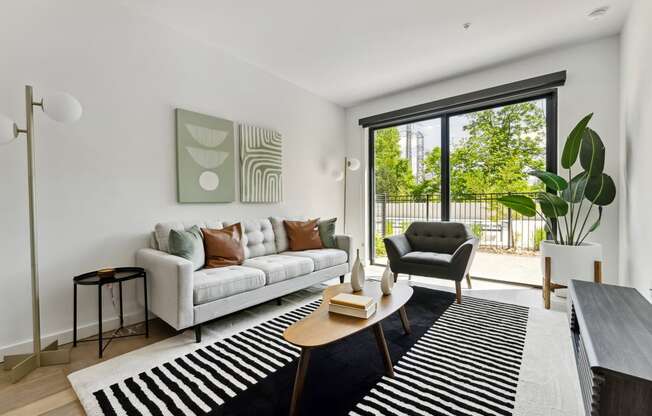 a living room with a white couch and a black and white rug at Hydro, Richmond, 23224