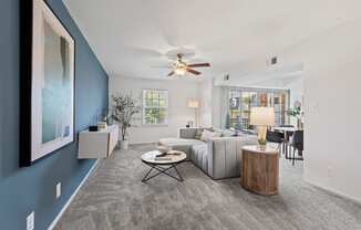 a living room with a couch and a ceiling fan