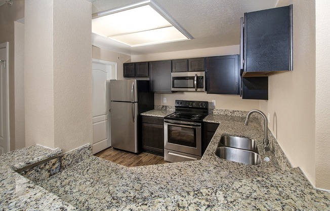 A2 Kitchen | Open | Stainless Steel Appliances | Granite countertops