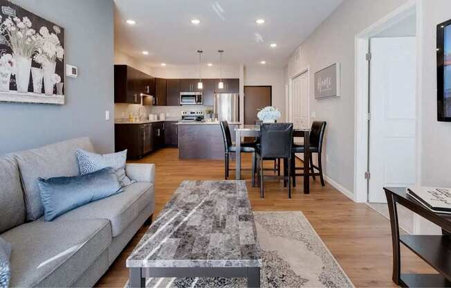 a living room and kitchen with a couch and a table. Circle Pines, MN Lexington Lofts