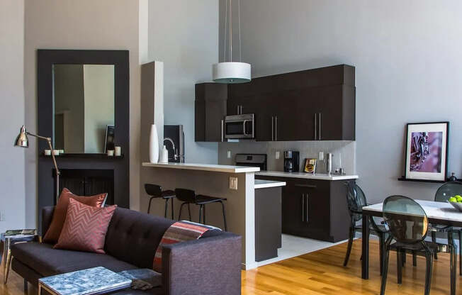 A modern living room with a black couch and a coffee table.