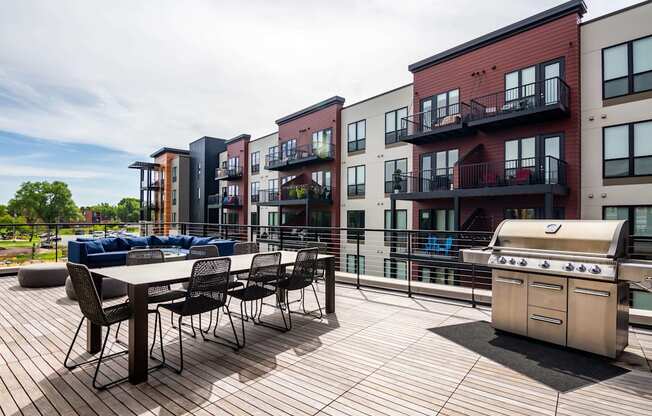 Outdoor deck with large dining table, a grill, and space to entertain.