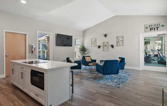 Community Clubhouse with Lounge Furniture and Kitchenette Area at Broadmoor Village Apartments located in West Jordan, UT.