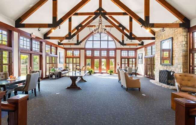 A large room with a high ceiling and a stone fireplace.
