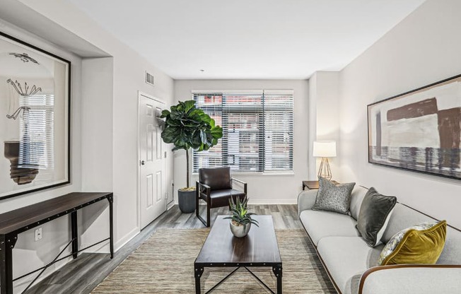 the living room of an apartment with a couch and a coffee table