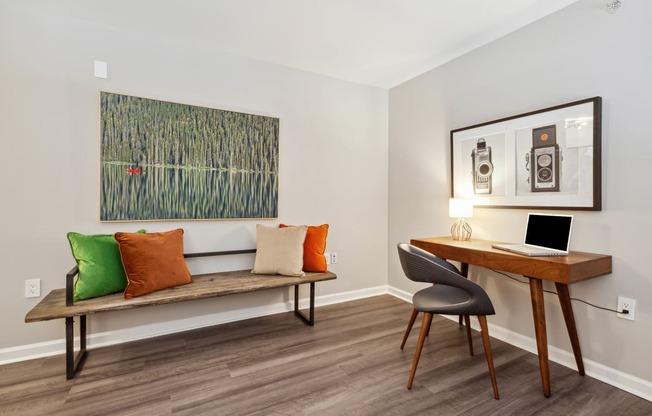 a room with a desk and chair and a painting on the wall at Metro 303, Hempstead New York