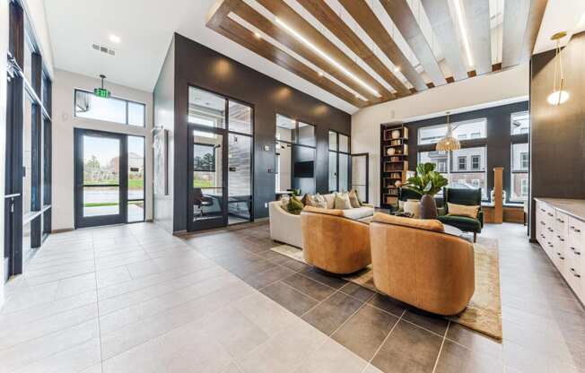 a lobby with couches and chairs and glass doors  at Plat 4 at Research Triangle, Durham, North Carolina