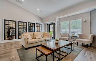 A living room with a white couch and a coffee table.