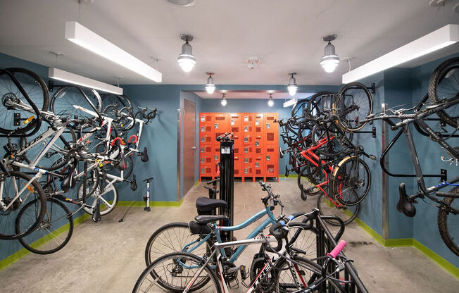 a room with many bikes on the wall and a wall of orange boxes