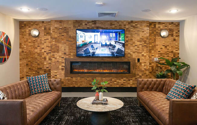 a living room with couches and a television on the wall