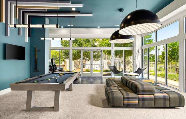 a billiards room with a pool table and couches