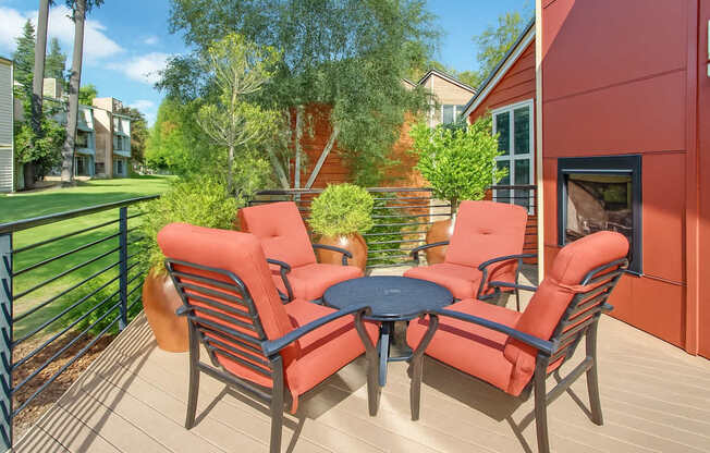 A patio with a table and four chairs.
