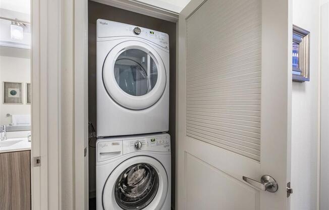 a white washer and dryer in a small room