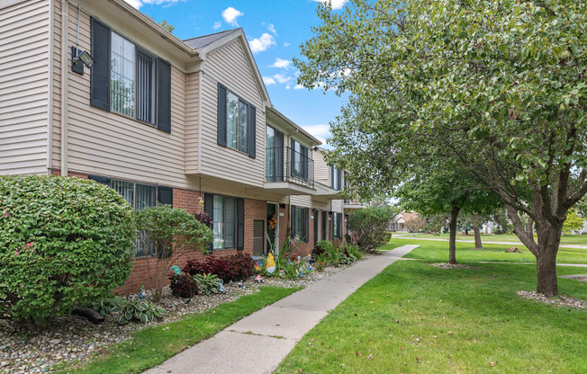 A residential area with a building and a tree.