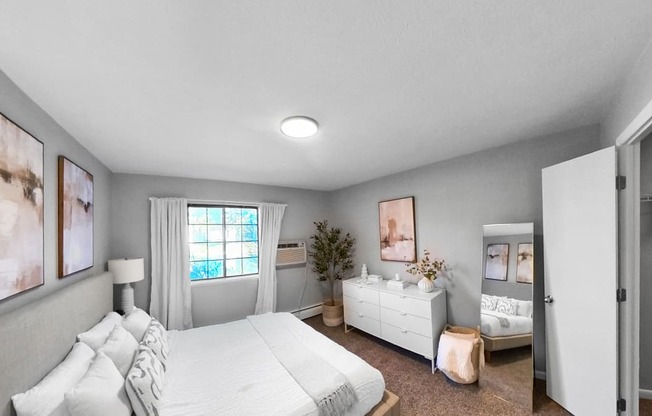 a bedroom with a bed and a dresser and a window