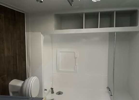 A modern bathroom with a shower and a toilet.
