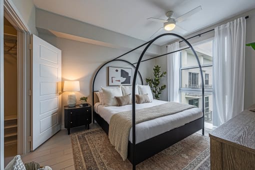 a bedroom with a bed and a ceiling fan