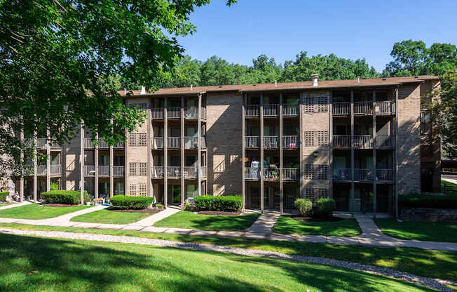 A large apartment complex with a green lawn in front.
