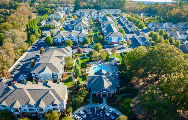 a aerial view of a neighborhood with houses and a swimming pool