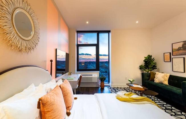 a hotel room with a bed and a large window at The Irvine, Pennsylvania, 19143