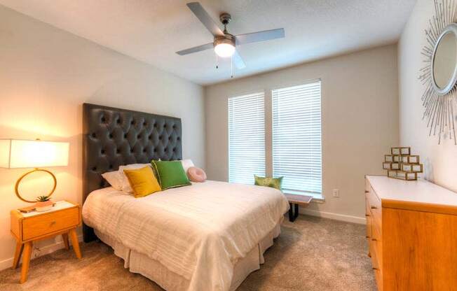 a bedroom with a large bed and a ceiling fan  at Fusion, Jacksonville, 32256