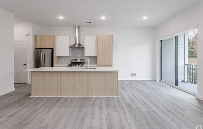 A modern kitchen with a stainless steel refrigerator and a wooden island.
