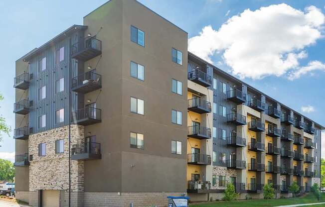 an image of an apartment building on a cloudy day. Circle Pines, MN Lexington Lofts