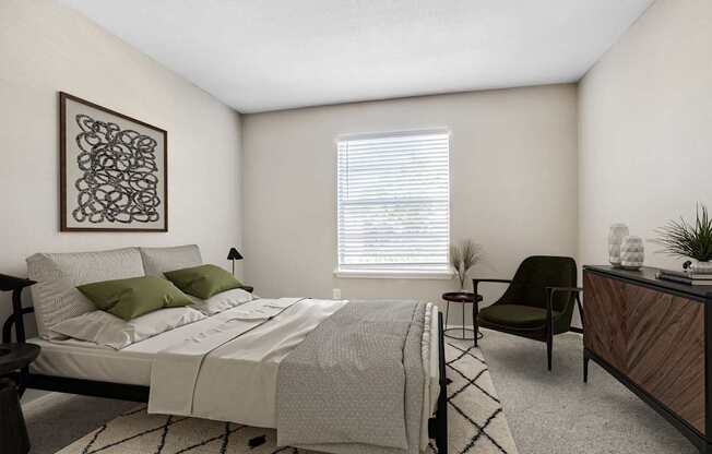 Apartments for Rent in Houston, TX 77036 – Artisan West – A bedroom with a bed, chair, and a plant.