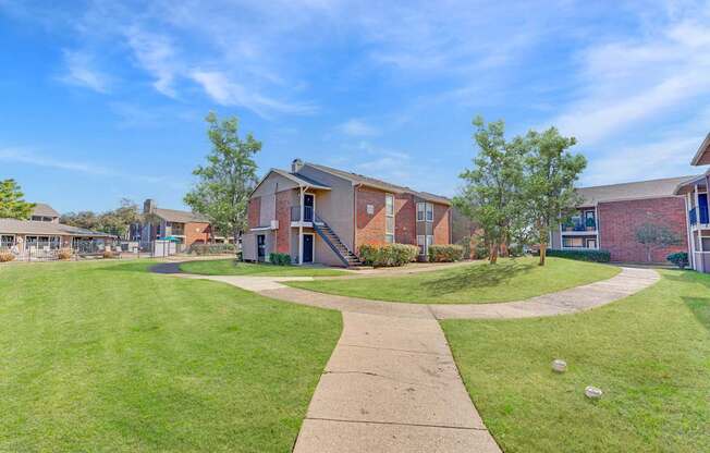 A sunny day at a residential area with houses and a clear blue sky.