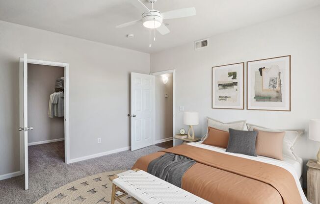 a bedroom with a bed and a ceiling fan