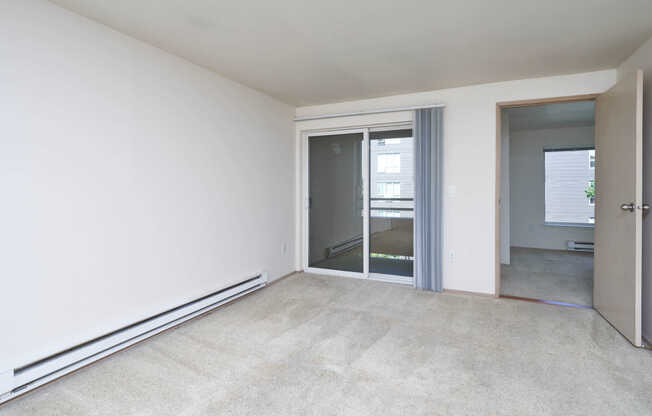 Carpeted Living Room with Balcony