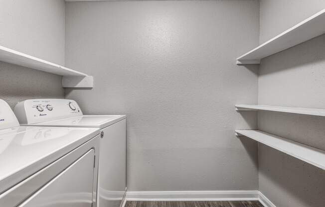 an empty laundry room with a washer and dryer